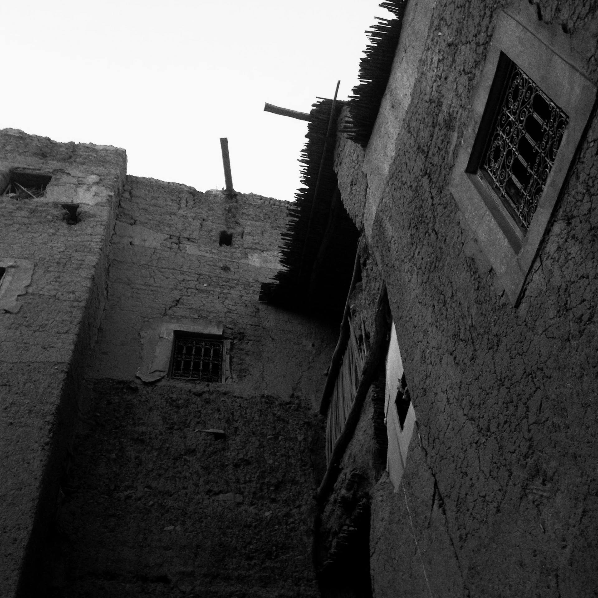 A vintage black-and-white photo of the Alcatraz cellhouse exterior, hinting at the stories held within its walls.