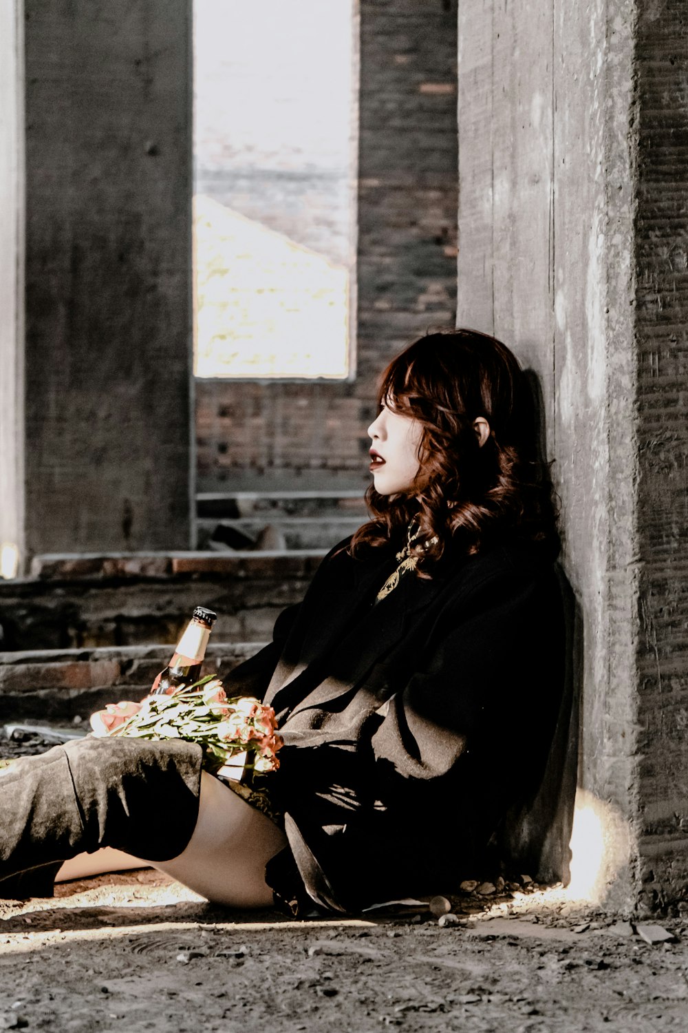 woman in black long sleeve shirt sitting on concrete stairs