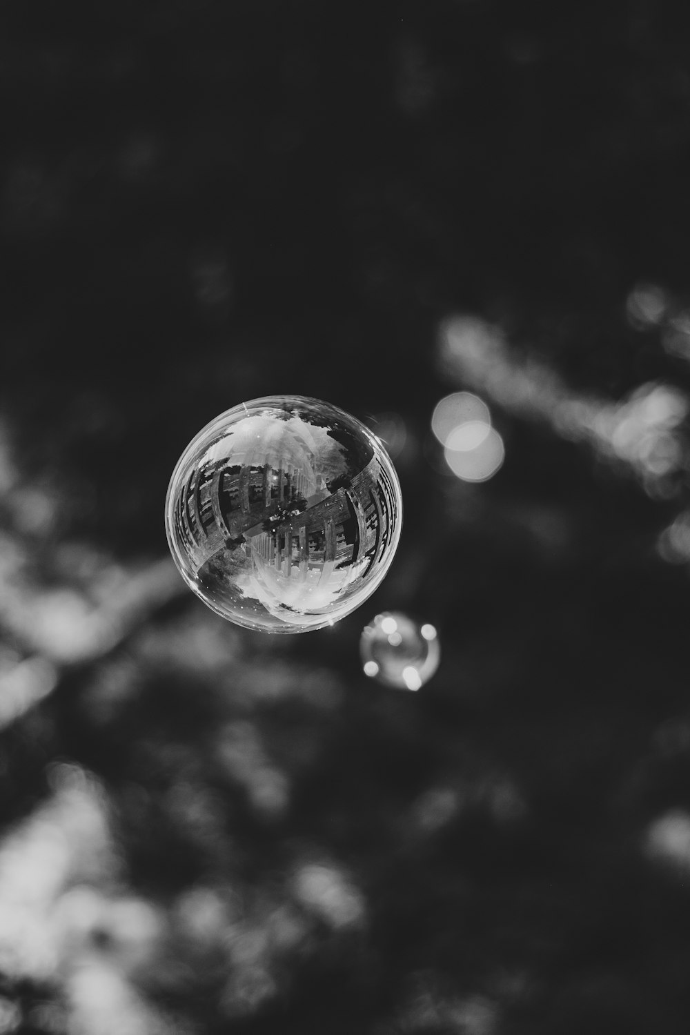 grayscale photo of bubble on mid air