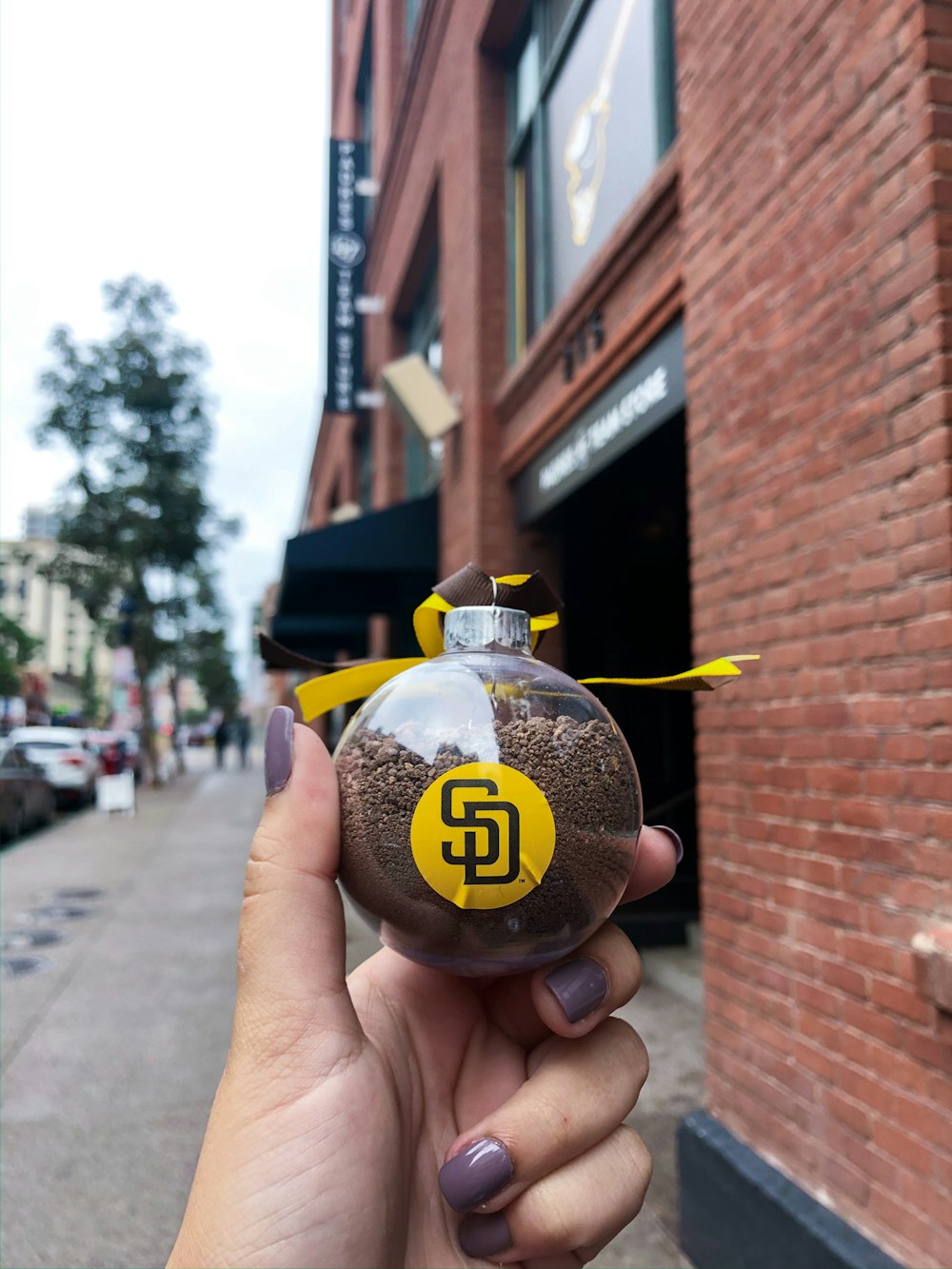 person holding black and yellow glass ball