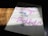 A piece of paper with a handwritten motivational quote in cursive and print styles, displayed on a wooden surface with light and shadow creating a dramatic effect.