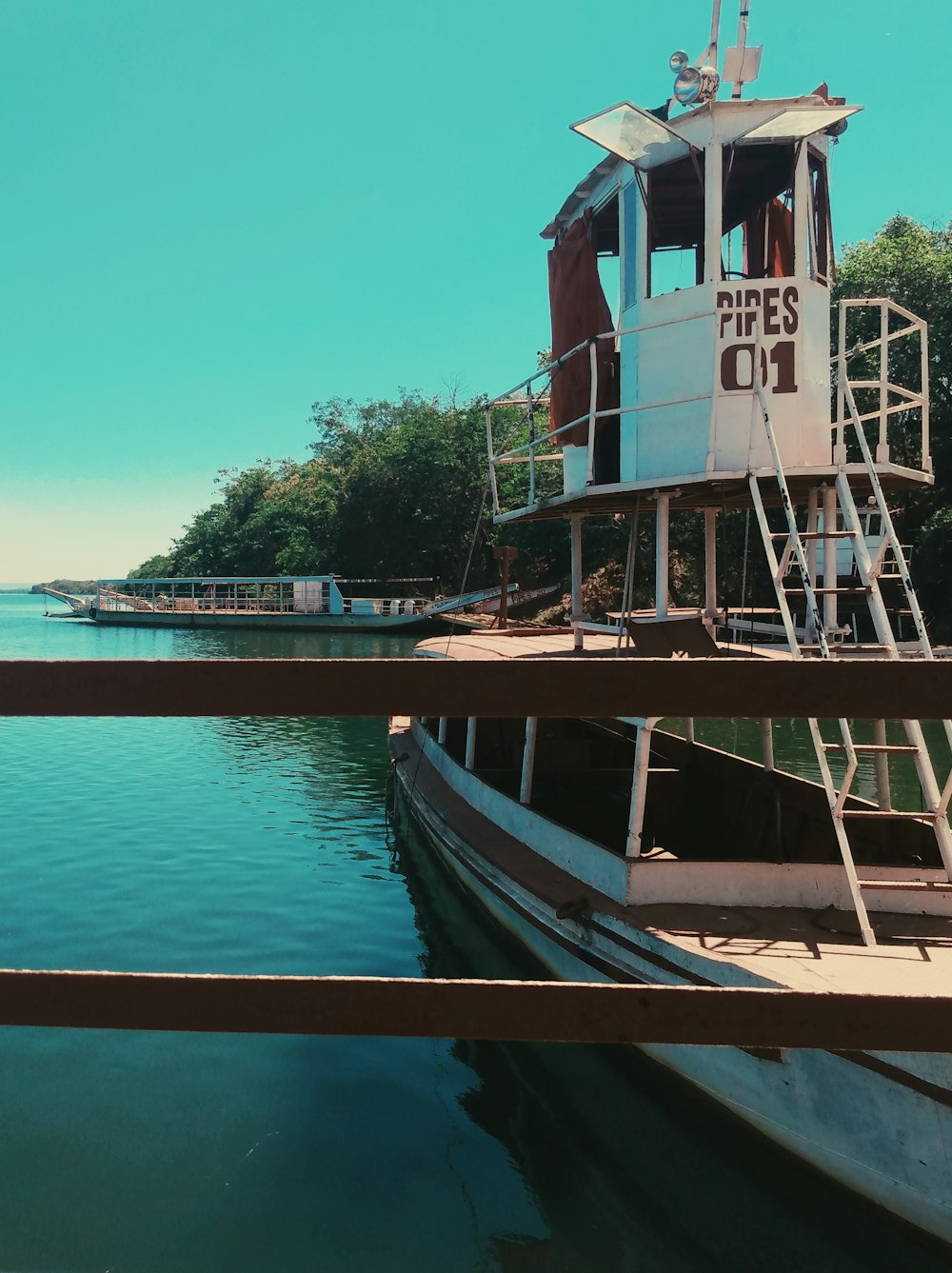 white and brown boat on blue sea under blue sky during daytime