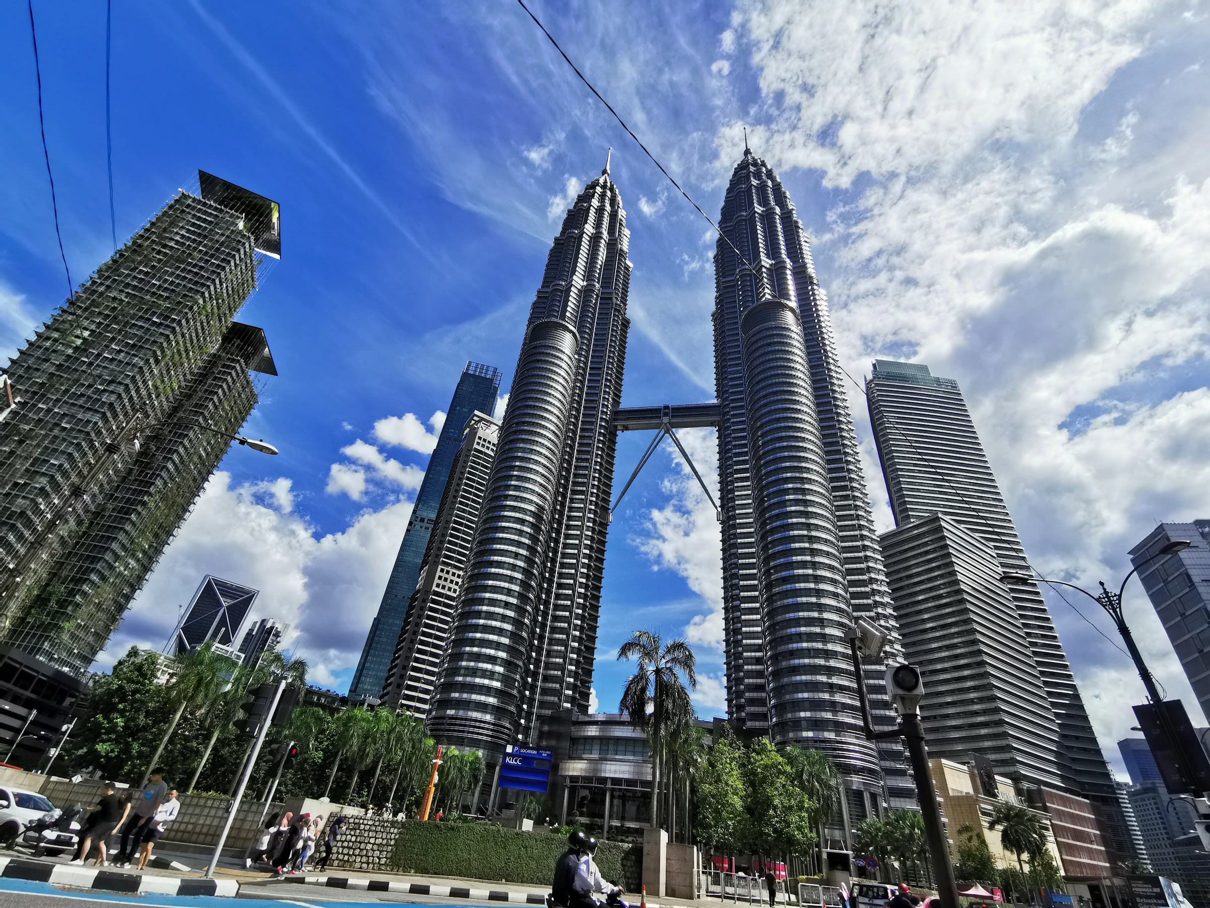 People walking near high-rise apartment towers