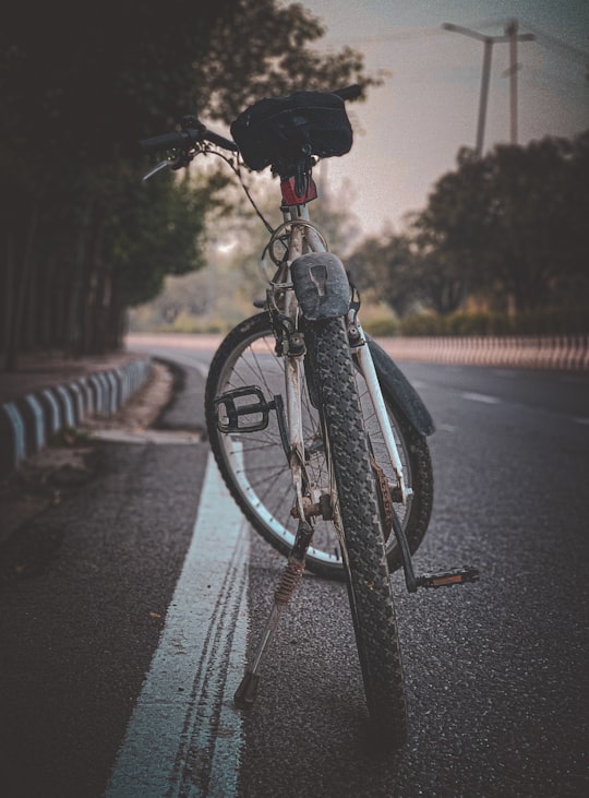 black bicycle on road during daytime in New Delhi India