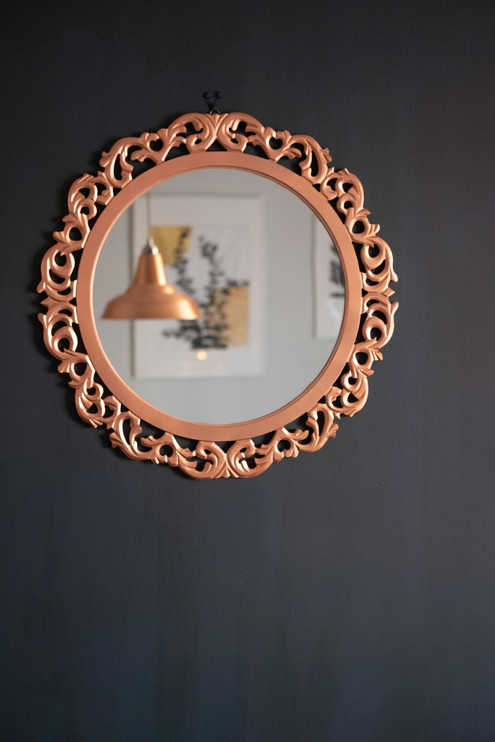 brass round framed mirror on black textile