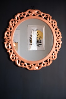 oval brown wooden framed mirror