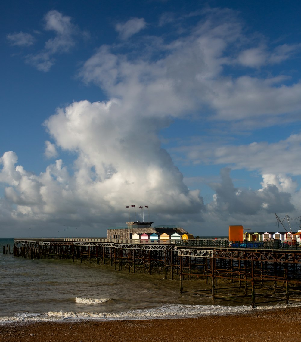 white and black ship on sea under white clouds and blue sky during daytime