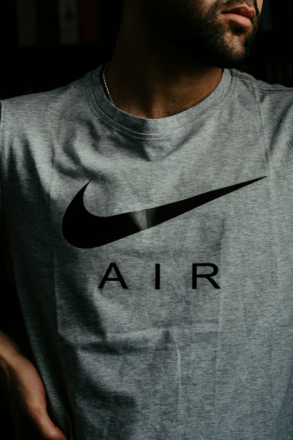 man in gray and black nike crew neck t-shirt