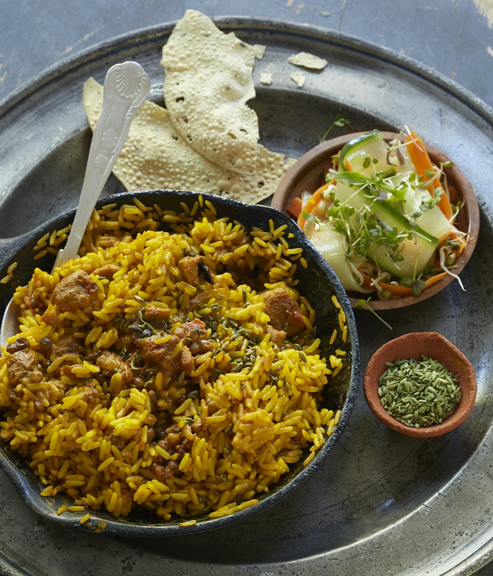 black ceramic bowl with yellow rice