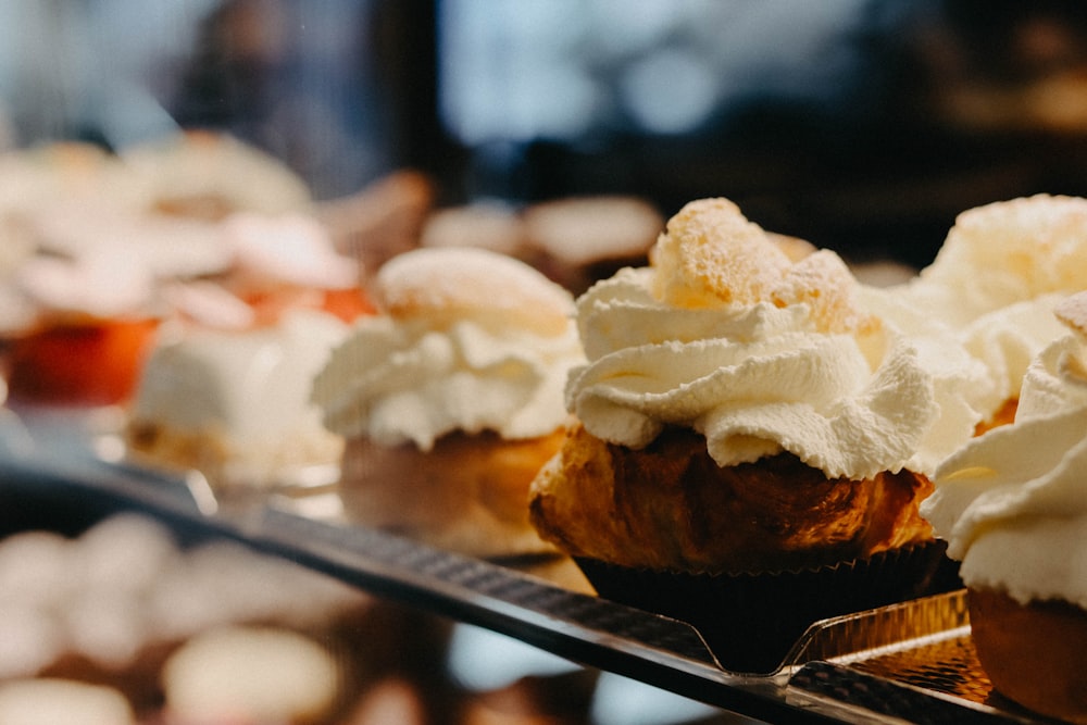 brown and white pastry on black tray