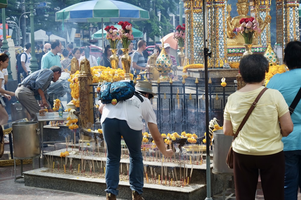 a woman standing in front of a shrine