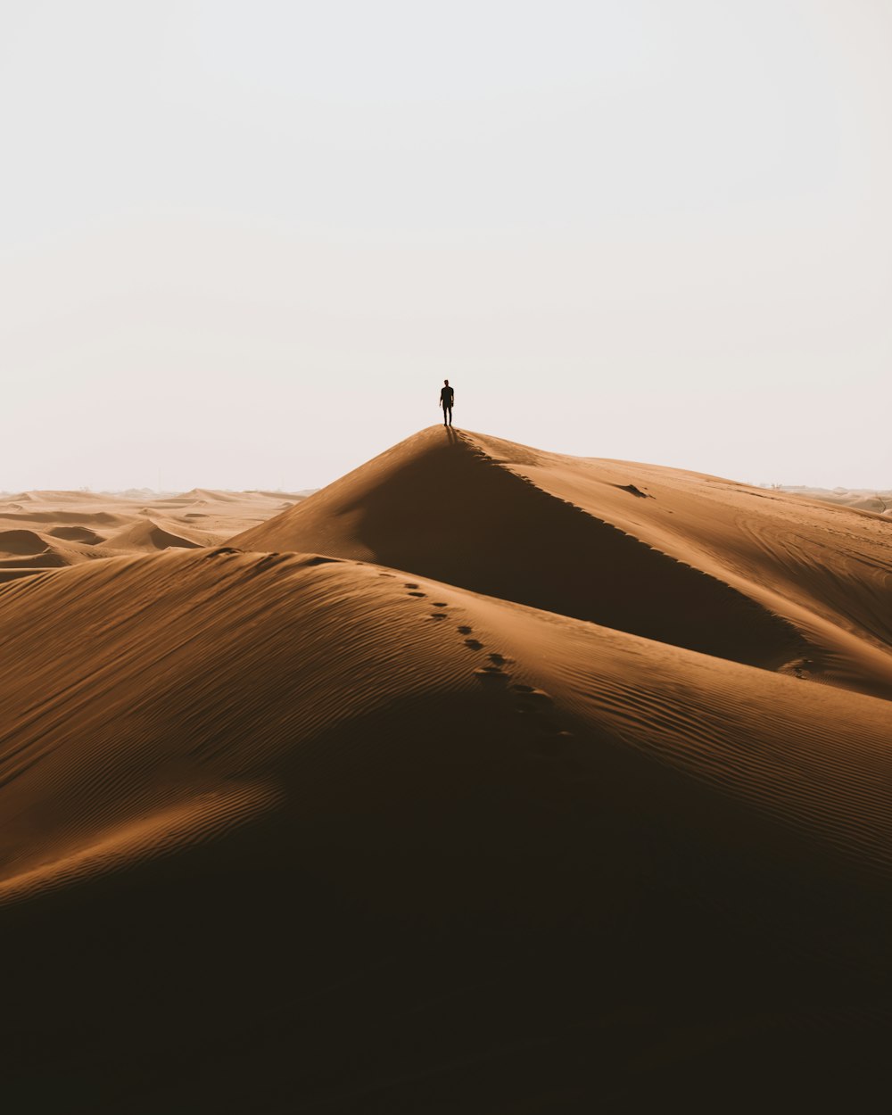 person walking on desert during daytime