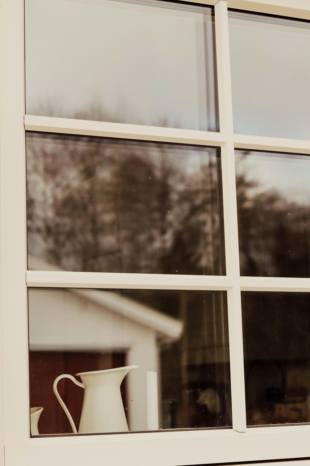 white ceramic mug on window