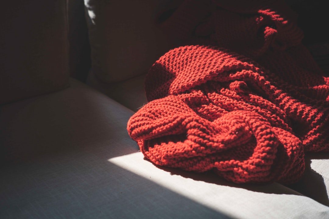 red knit textile on black textile