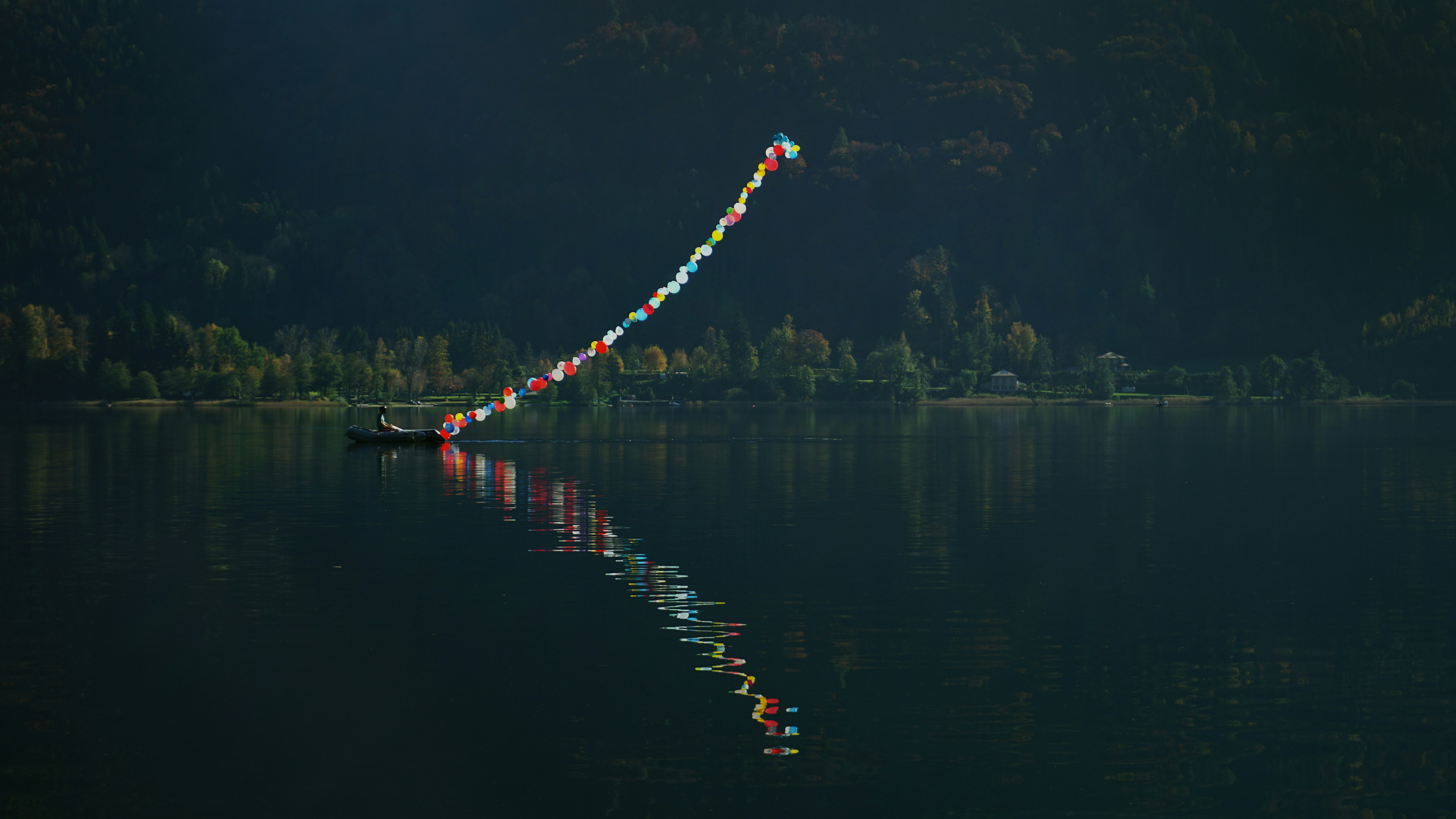 red and white lighted boat on water during night time