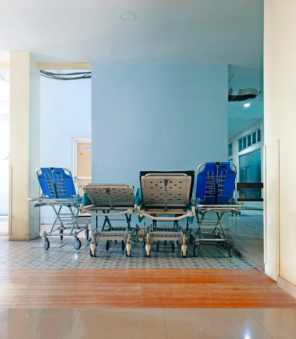 black metal framed blue padded chairs