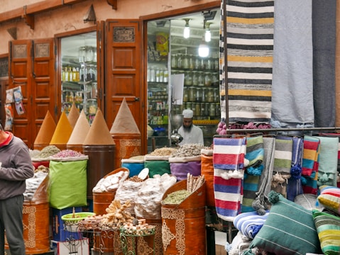 Colorful Indian market scene with spices, textiles, and smiling locals.