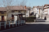 Terraced houses lining a quiet street shaded by greenery near the golf fairway