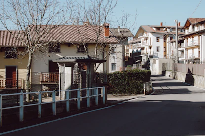 A quiet street with several distressed houses, illustrating typical properties we handle.