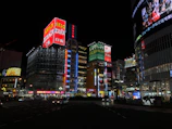 A bustling cityscape of Tokyo at night with neon lights and skyscrapers