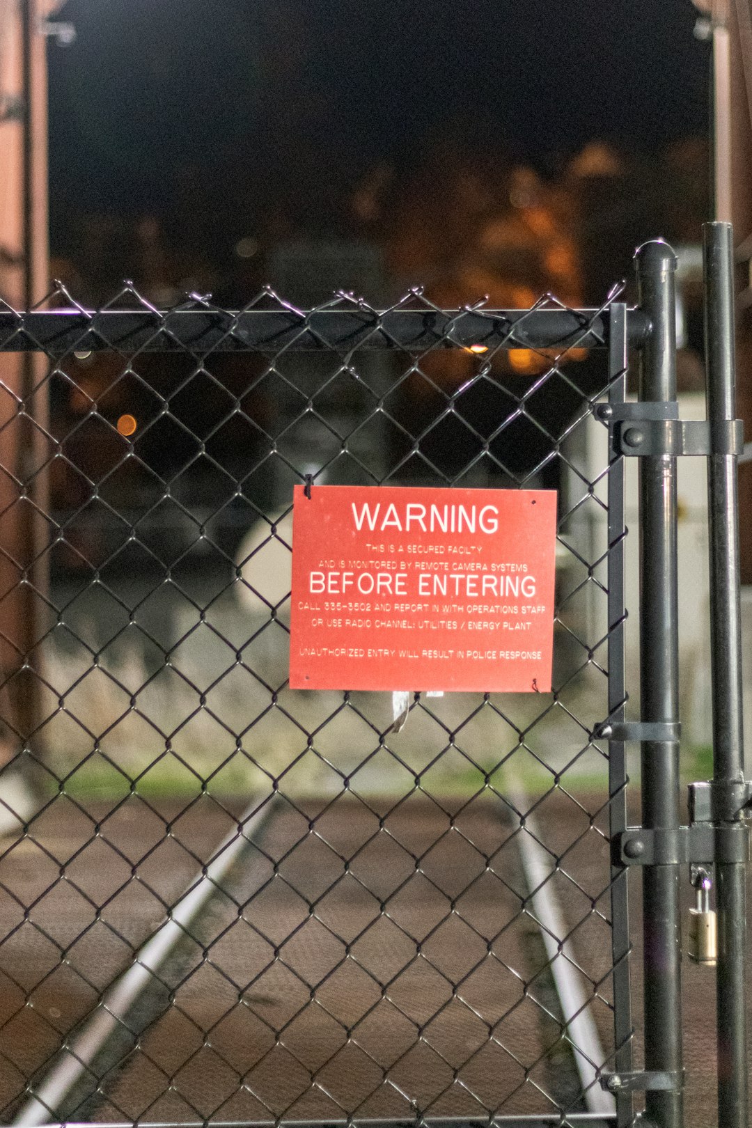 red and white quote on gray metal fence