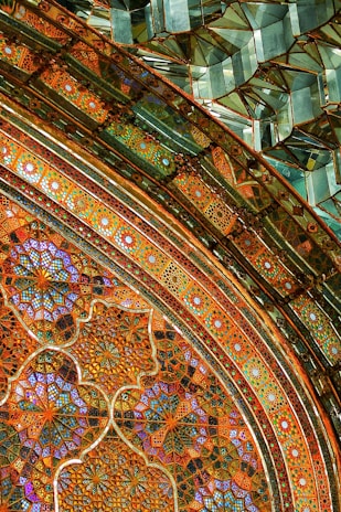 Intricate geometric patterns and mosaics with vibrant colors, featuring both circular and linear designs. The artwork combines ornate detailing and symmetry, creating a sense of depth and texture.