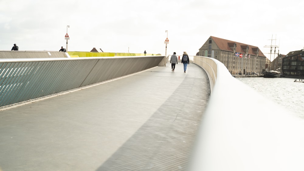 people walking on gray concrete bridge during daytime