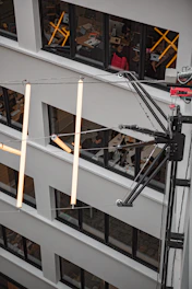 Modern office building with visible wireless network infrastructure and employees working on laptops.