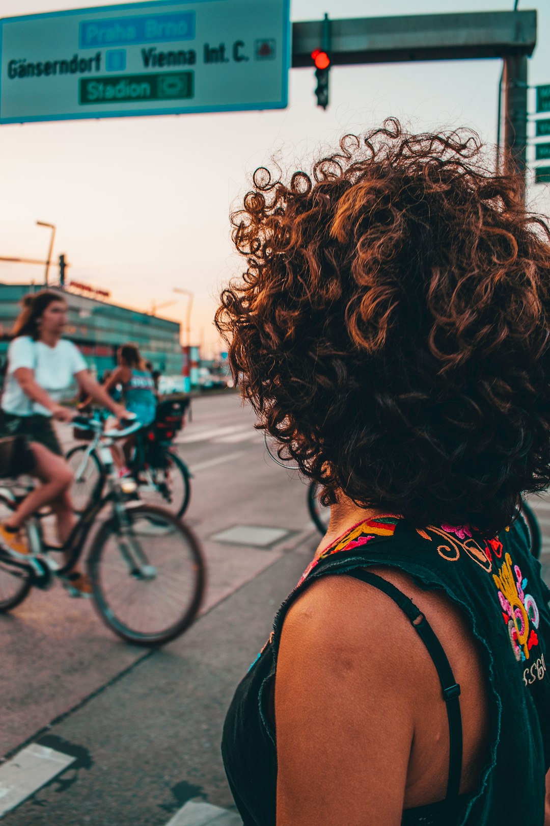 woman in black tank top riding bicycle during daytime