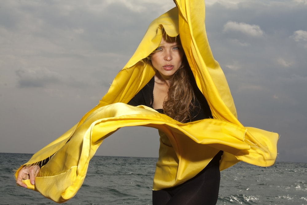 woman in black long sleeve shirt wearing yellow scarf