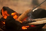 Artisan roasting makhana seeds in a traditional pan over an open flame.