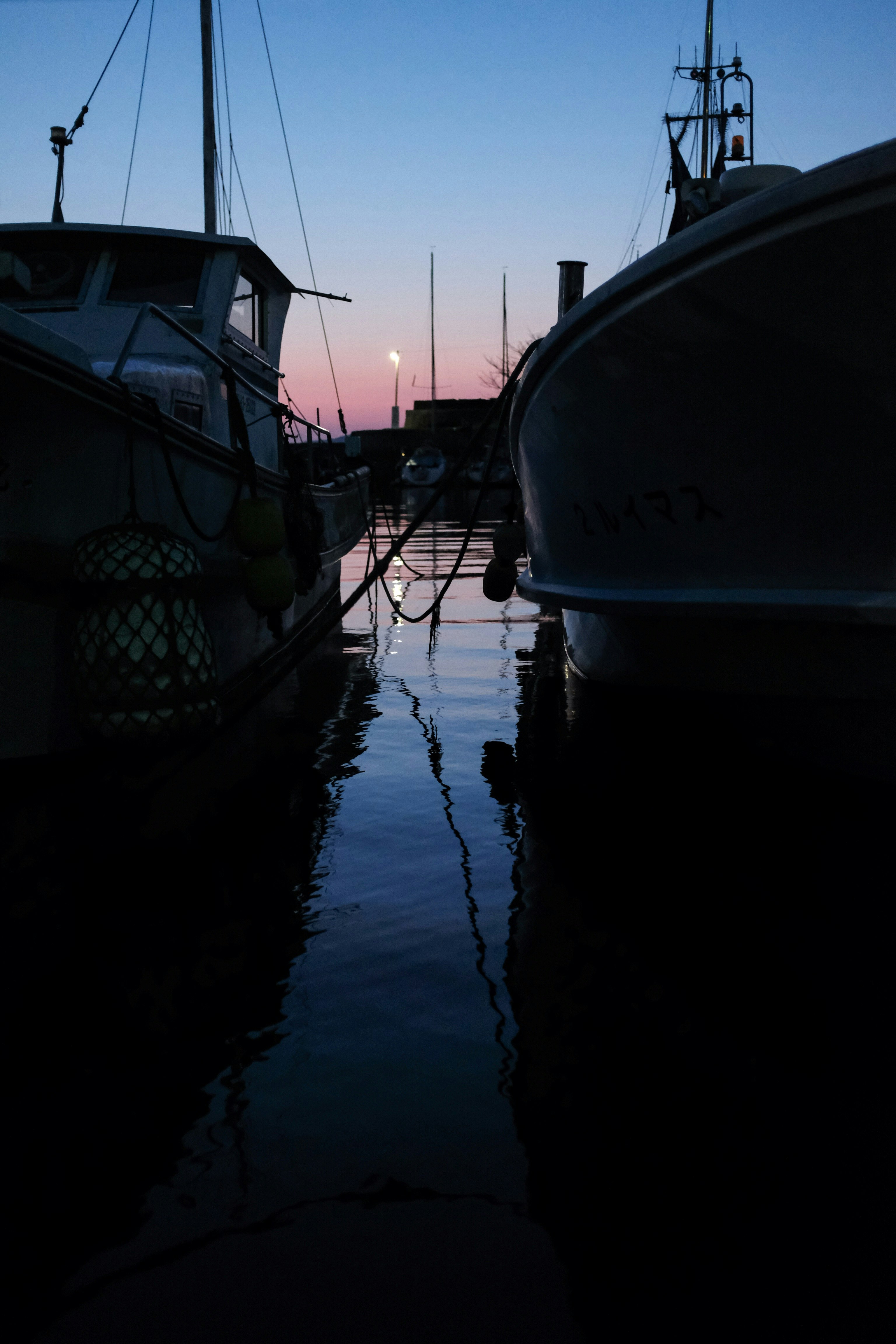 white and blue boat on water during daytime