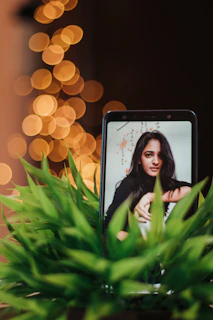 A cozy home setting with a smartphone displaying a vibrant, studio-quality family photo.