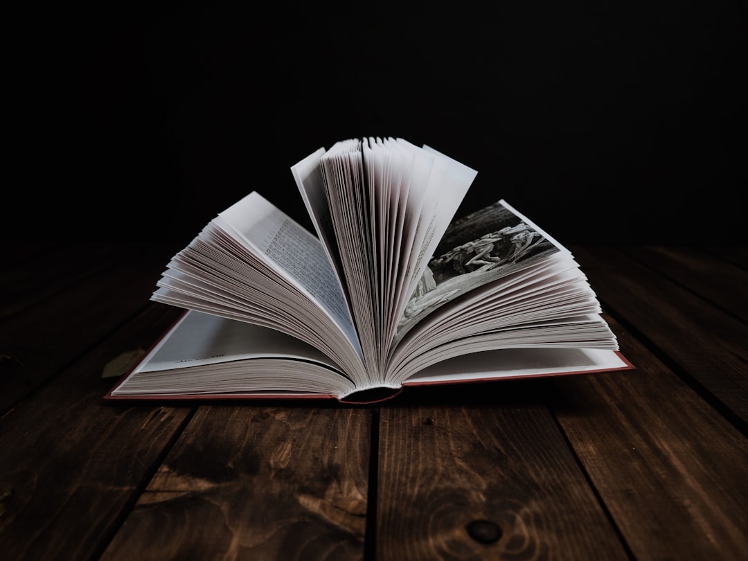 white book on brown wooden table