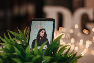 Elegant gold and off-white themed image showing a smartphone with the Bink app open, surrounded by beauty products.