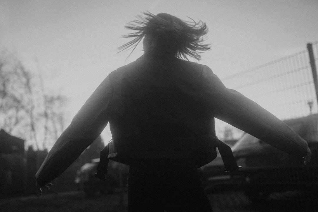 silhouette of woman standing during sunset