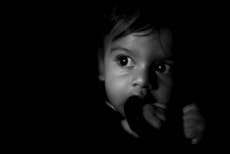 grayscale photo of boys face