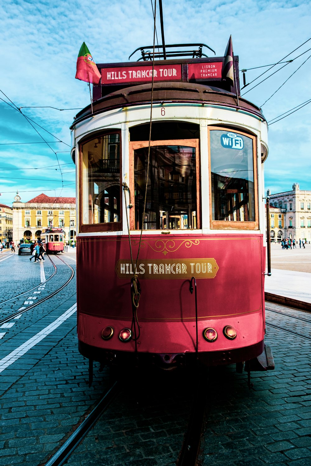 red and white tram on road during daytime