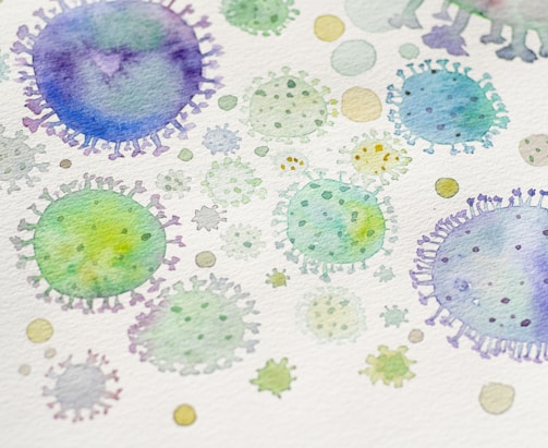 Watercolor illustration depicting various abstract, circular shapes resembling microscopic views of viruses or cells in shades of green, blue, and purple.
