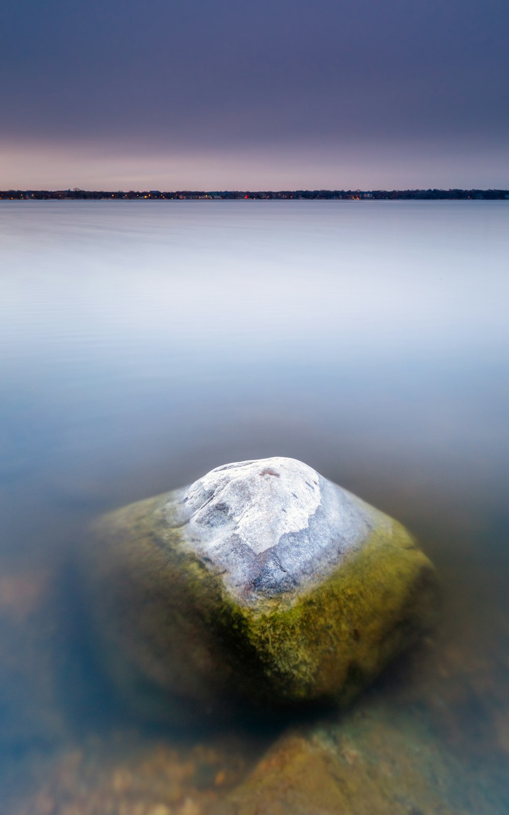 gray rock on body of water during daytime