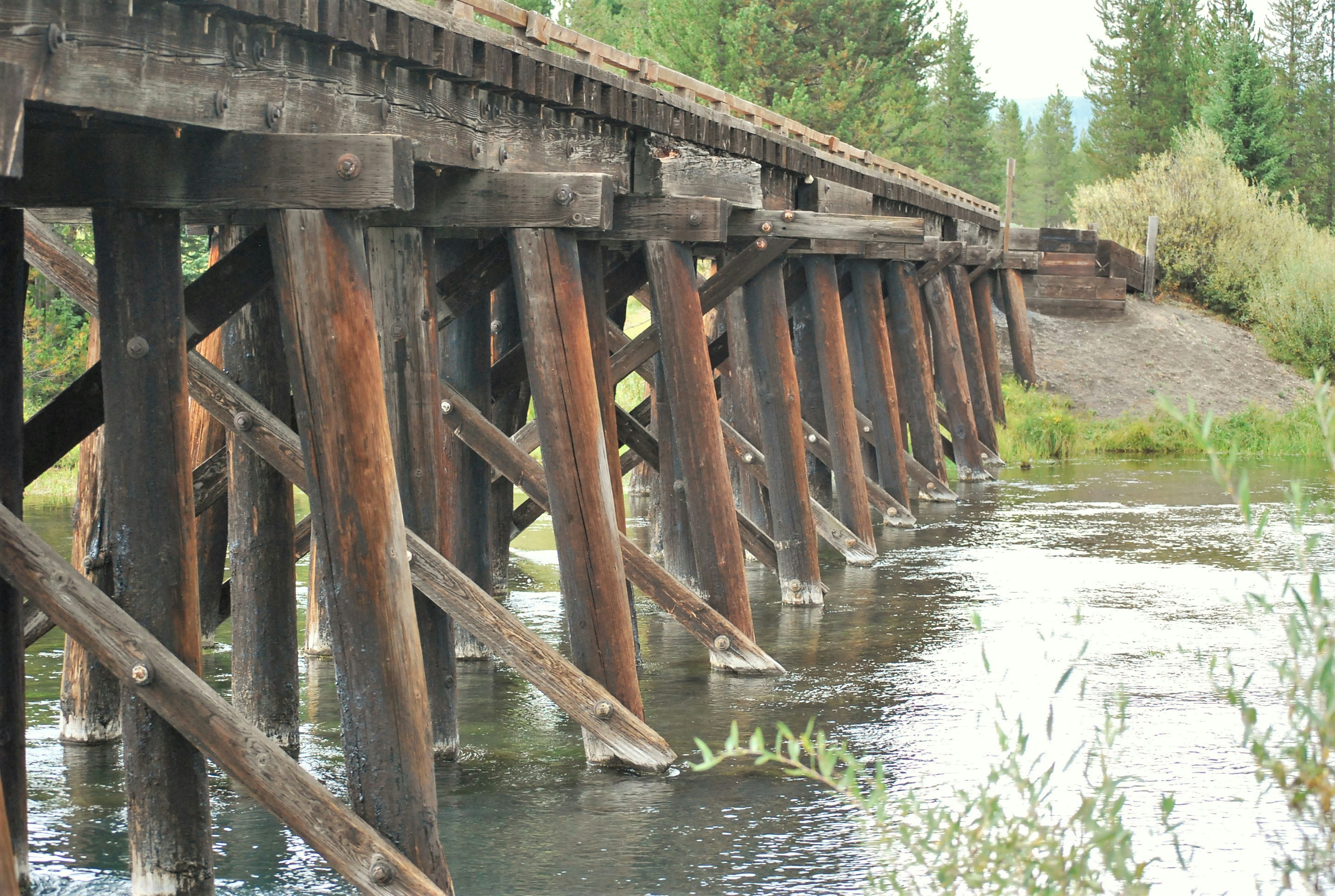 brown wooden bridge over river