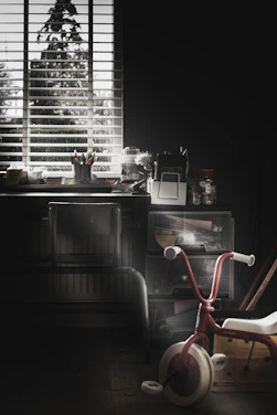 red and stainless steel chair beside brown wooden desk