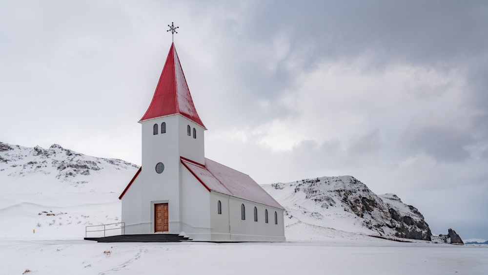 white and black church on snow covered ground