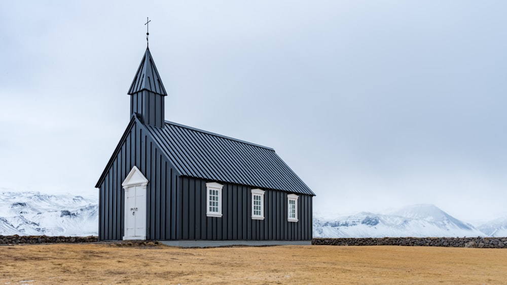 gray and white wooden church under gray sky
