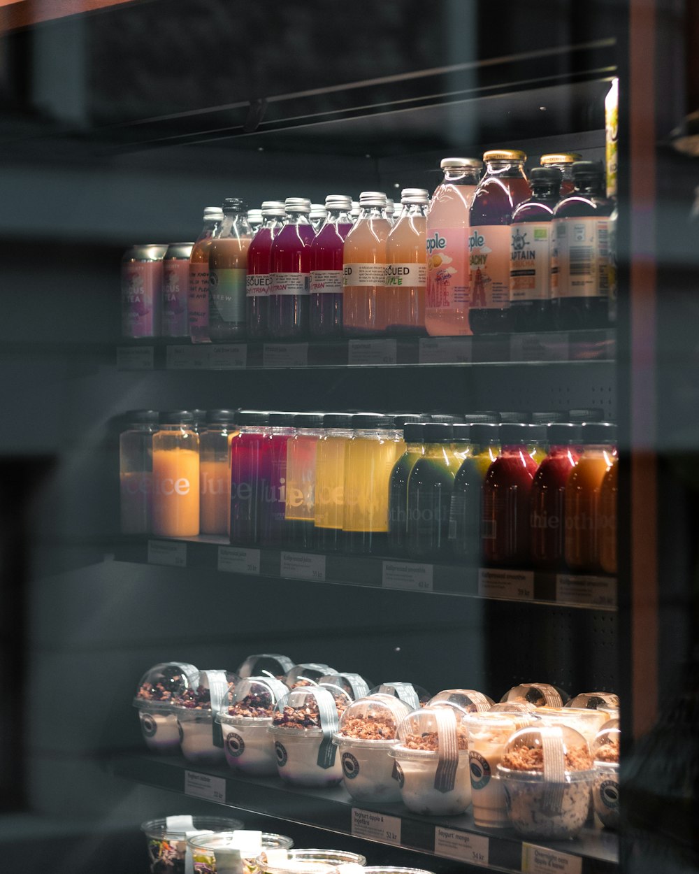 assorted bottles on glass shelf