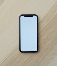 white smartphone on brown wooden table