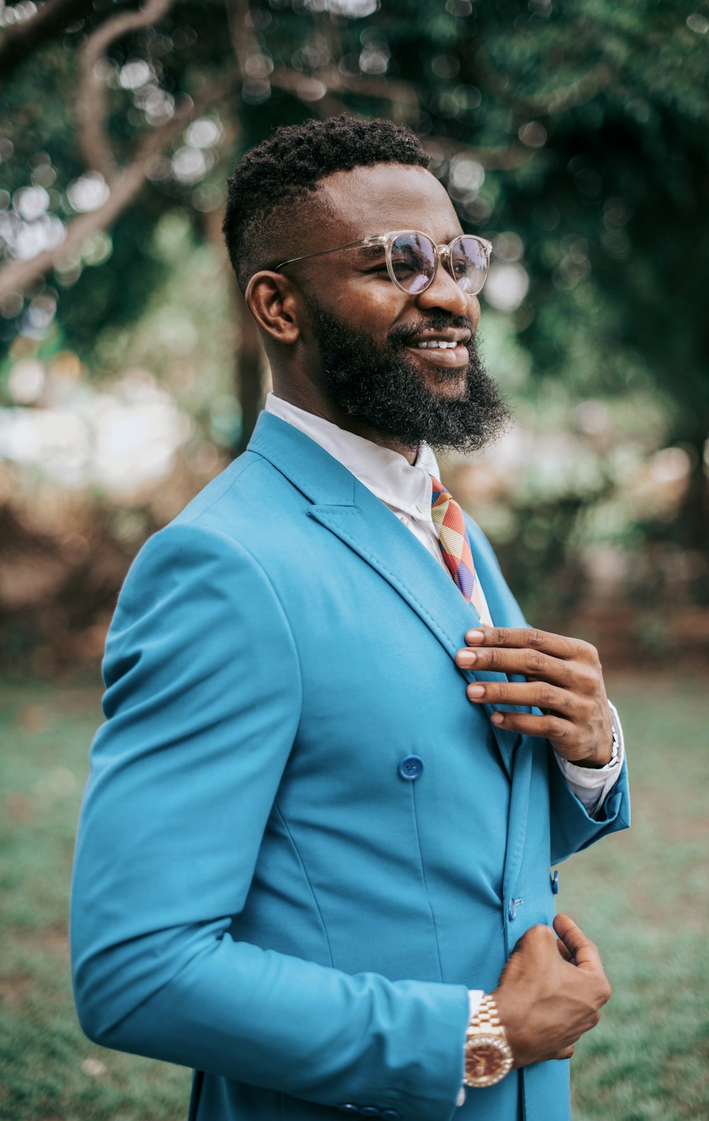 man in blue suit jacket wearing eyeglasses