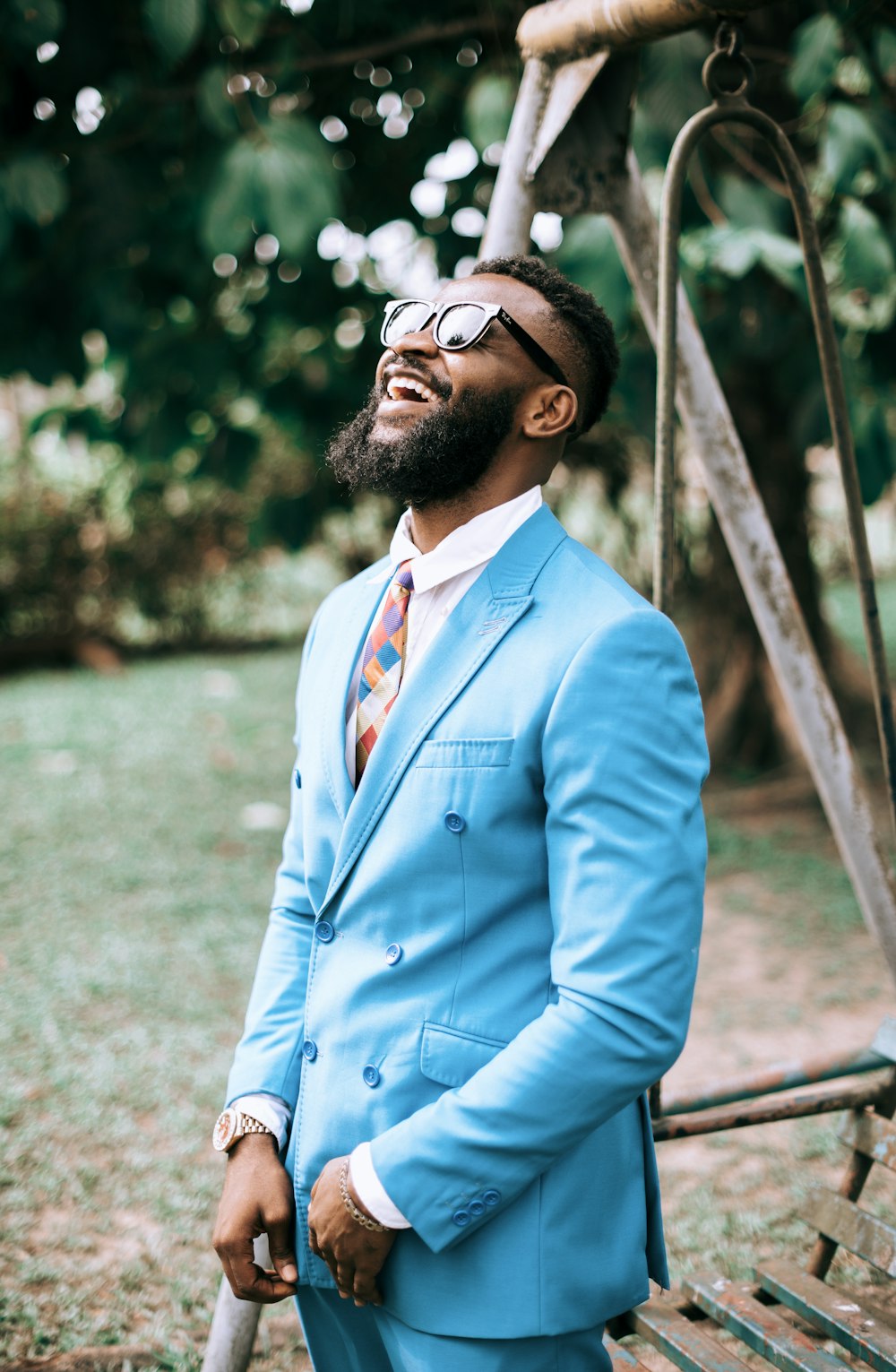 man in blue suit jacket wearing black sunglasses