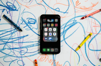 black iphone 4 on white and blue textile