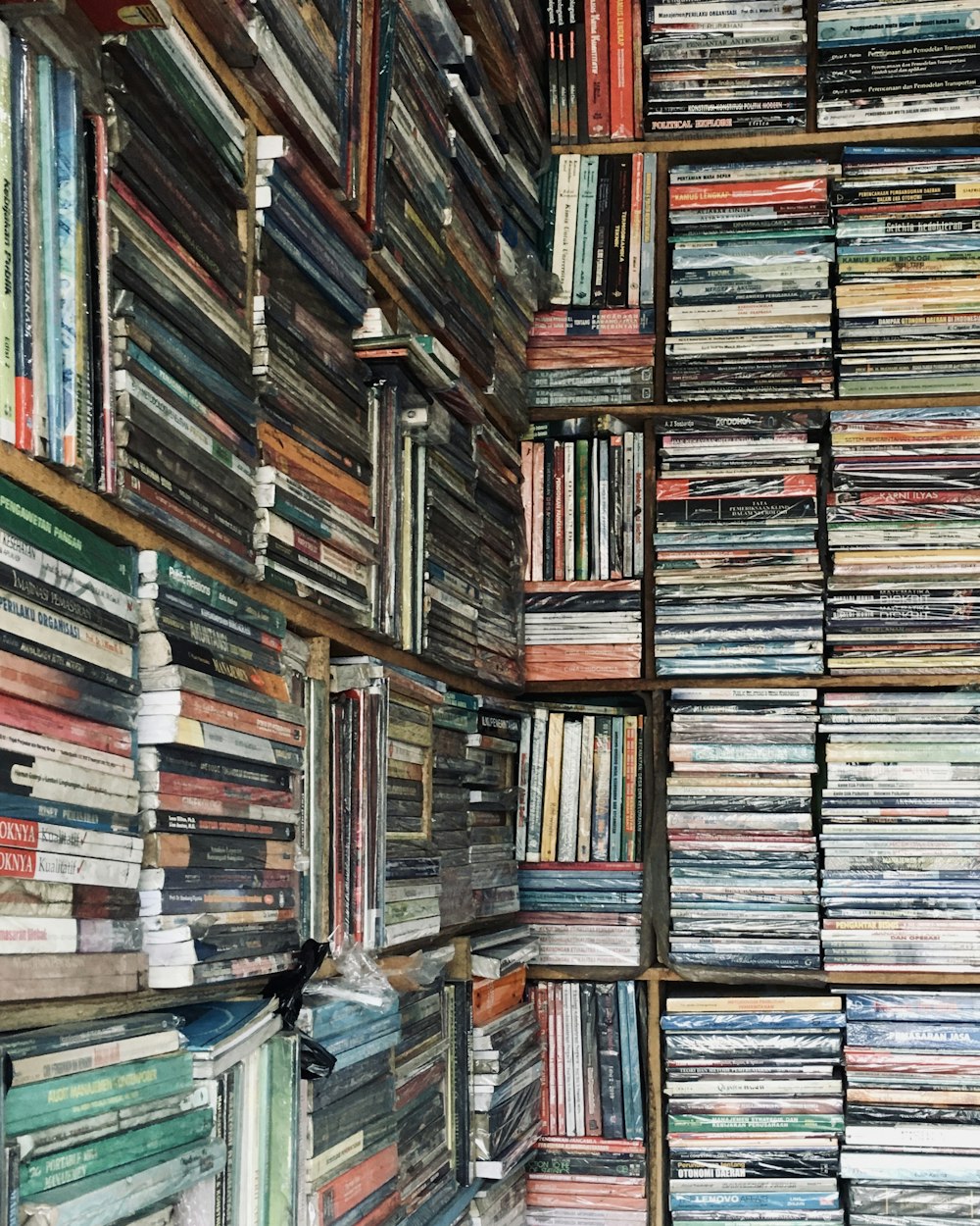 books on brown wooden shelf